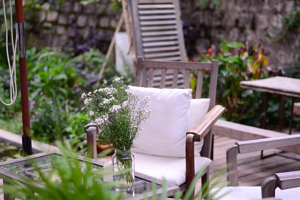 Flowers In Garden With Chair