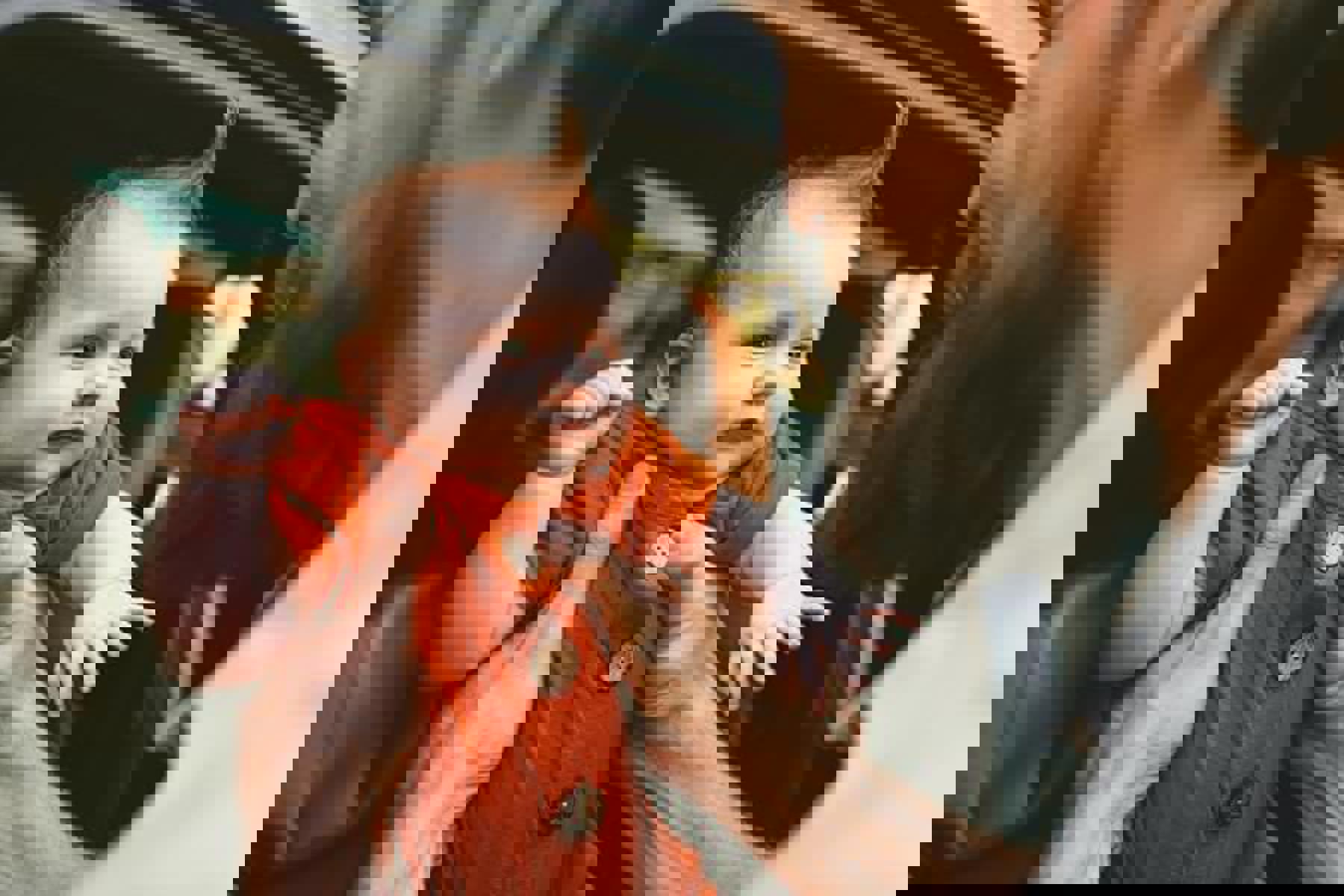 Man Holding Baby Orange Outfit