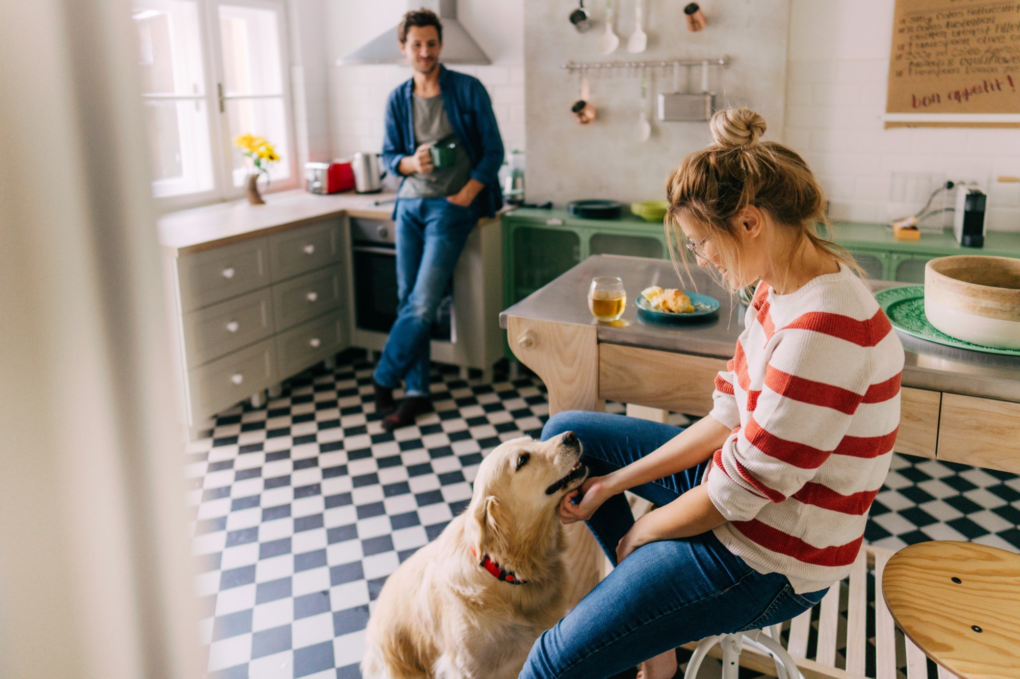 Couple In Kitchen With Labrador