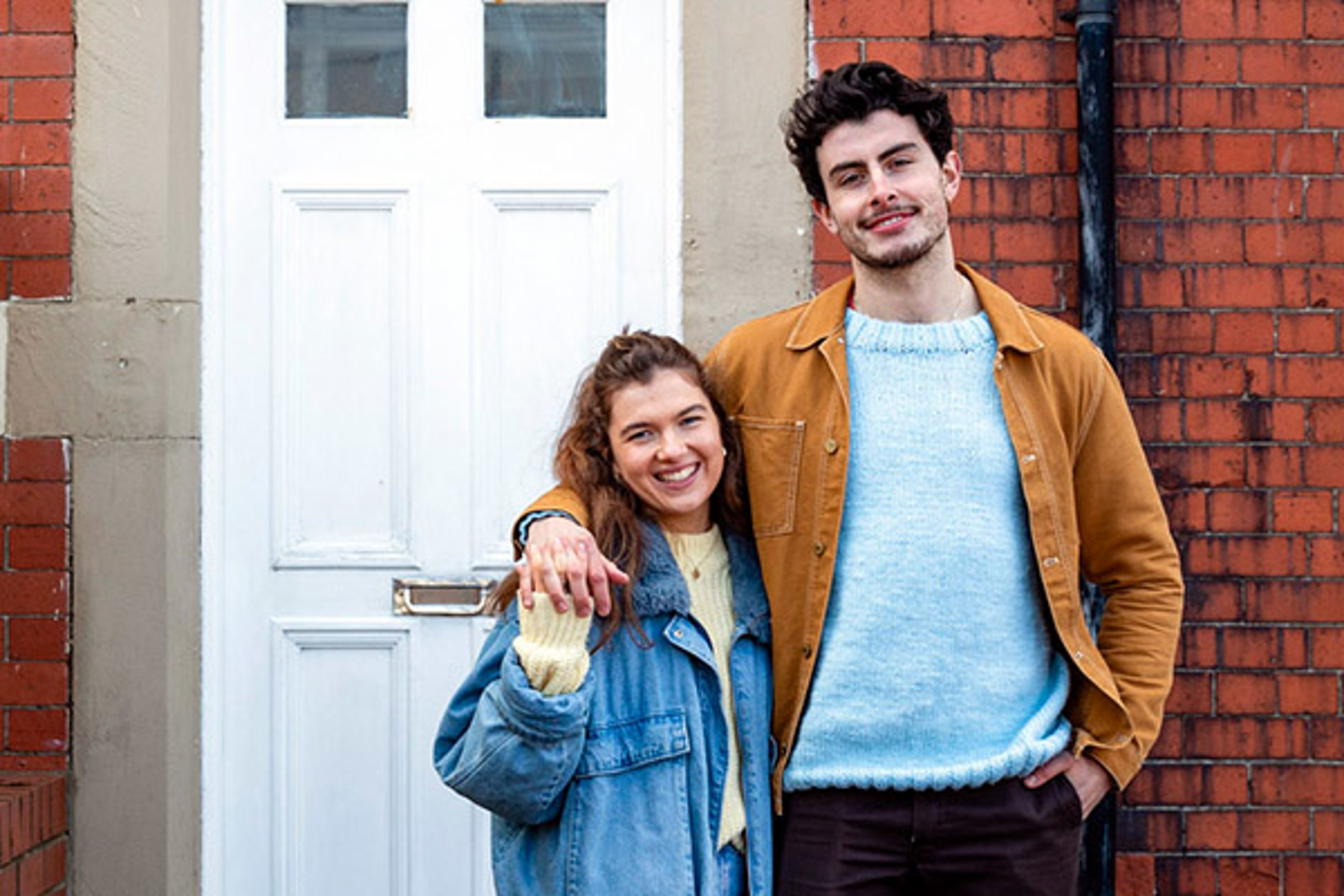 Couple outside first house