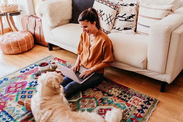 Woman Sat On Floor Laptop With Dog