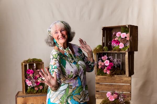 Woman Dancing In Front Of Flower Boxes