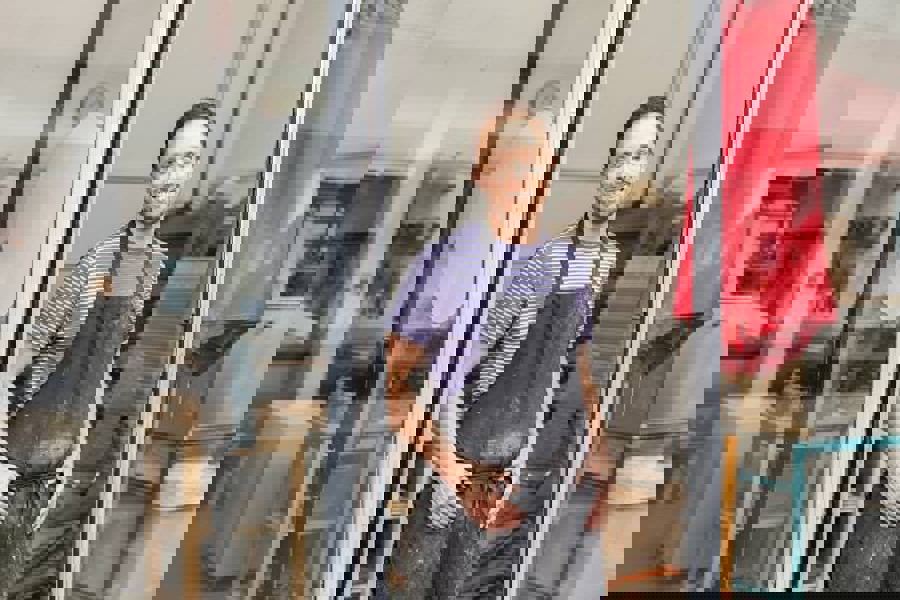 Man At Shop Door Wearing Apron